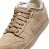 A NIKE SB DUNK LOW PRO B PARACHUTE BEIGE sneaker with a striking white logo.