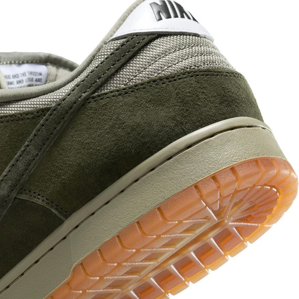 Close-up of the heel of a nike SB Dunk Low Pro B skate shoe in Sequoia/Light Army/White, featuring Pale Ivory nubuck accents, white logo, and a gum rubber outsole.