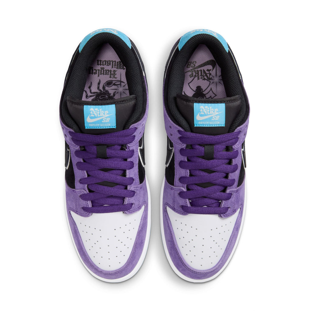 Top view of the nike SB Hayley Wilson Dunk Low Pro Court sneakers in Purple/Black-White-Lagoon Pulse, featuring purple suede overlays, white toe boxes, black accents, blue tongue tags, and lightweight premium cushioning.