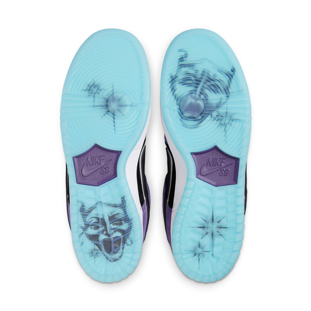 The NIKE SB Hayley Wilson Dunk Low Pro features translucent blue soles revealing the Nike SB logo and black comedy/tragedy mask graphics, crafted with premium materials for standout style.