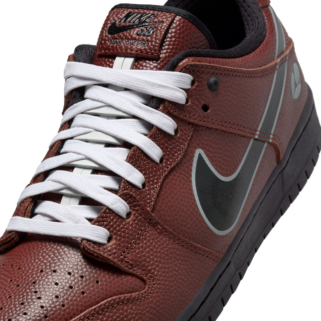 Close-up of the NIKE SB x Limo Dunk Low Pro in Dark Pony/Black-Silver-White, featuring football-textured brown leather, custom laces, black sole, and black swoosh on the side.