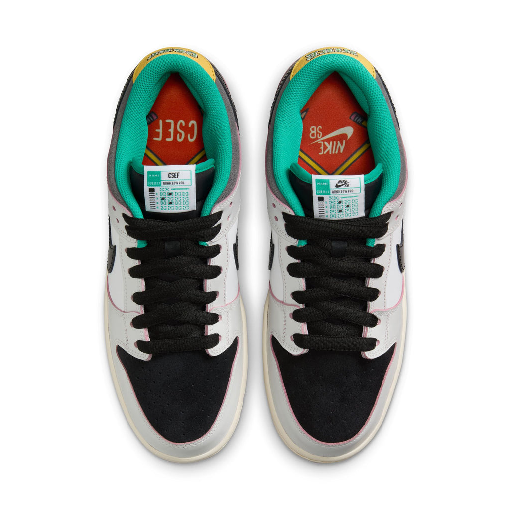 Top view of Nike SB x CSEF Dunk Low in Summit White/Black-White-Iron Grey featuring black laces, white and black panels, patent leather Swoosh, green inner lining, and red/yellow details. Inspired by the College Skateboarding Educational Foundation.