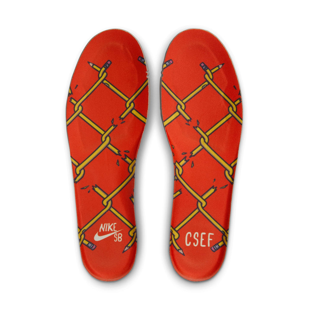 The NIKE SB x CSEF Dunk Low in Summit White/Black-White-Iron Grey features red insoles with yellow crisscross pencil graphics and "NIKE SB" & "CSEF" heel logos, celebrating the College Skateboarding Educational Foundation.