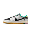 The NIKE SB x CSEF Dunk Low in Summit White/Black-White-Iron Grey features a white and black upper, black patent leather Swoosh, green accents, yellow heel, multicolor sole, and a small bull graphic by the heel.
