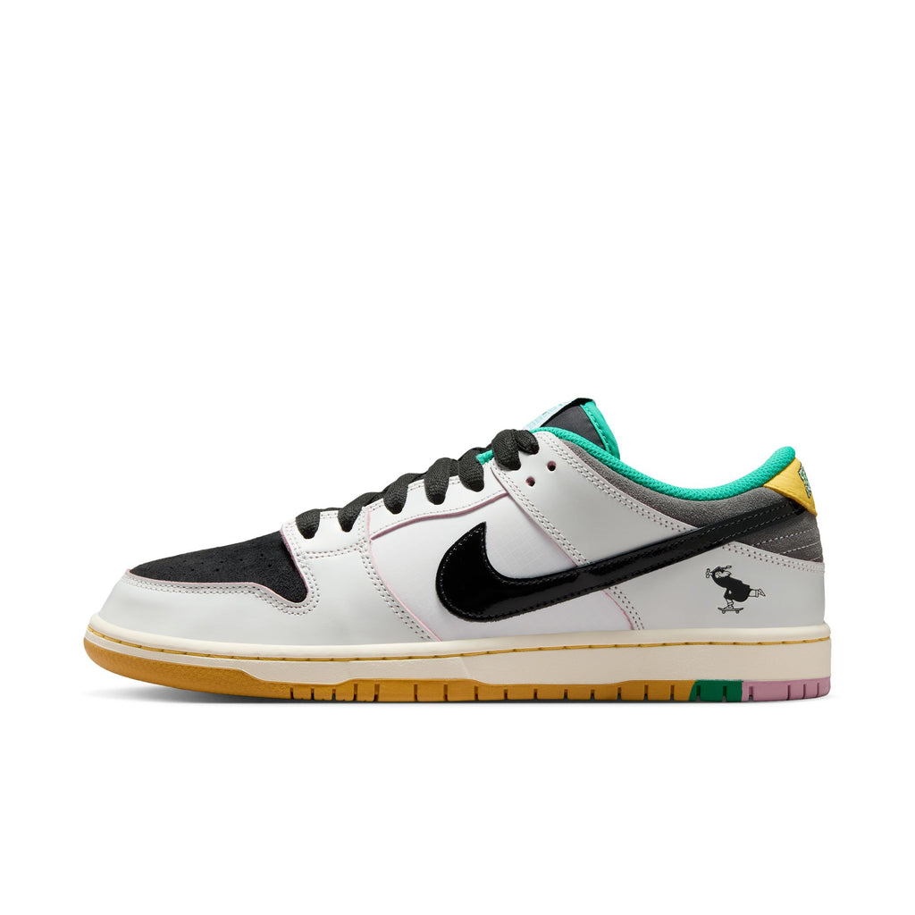 The NIKE SB x CSEF Dunk Low in Summit White/Black-White-Iron Grey features a white and black upper, black patent leather Swoosh, green accents, yellow heel, multicolor sole, and a small bull graphic by the heel.