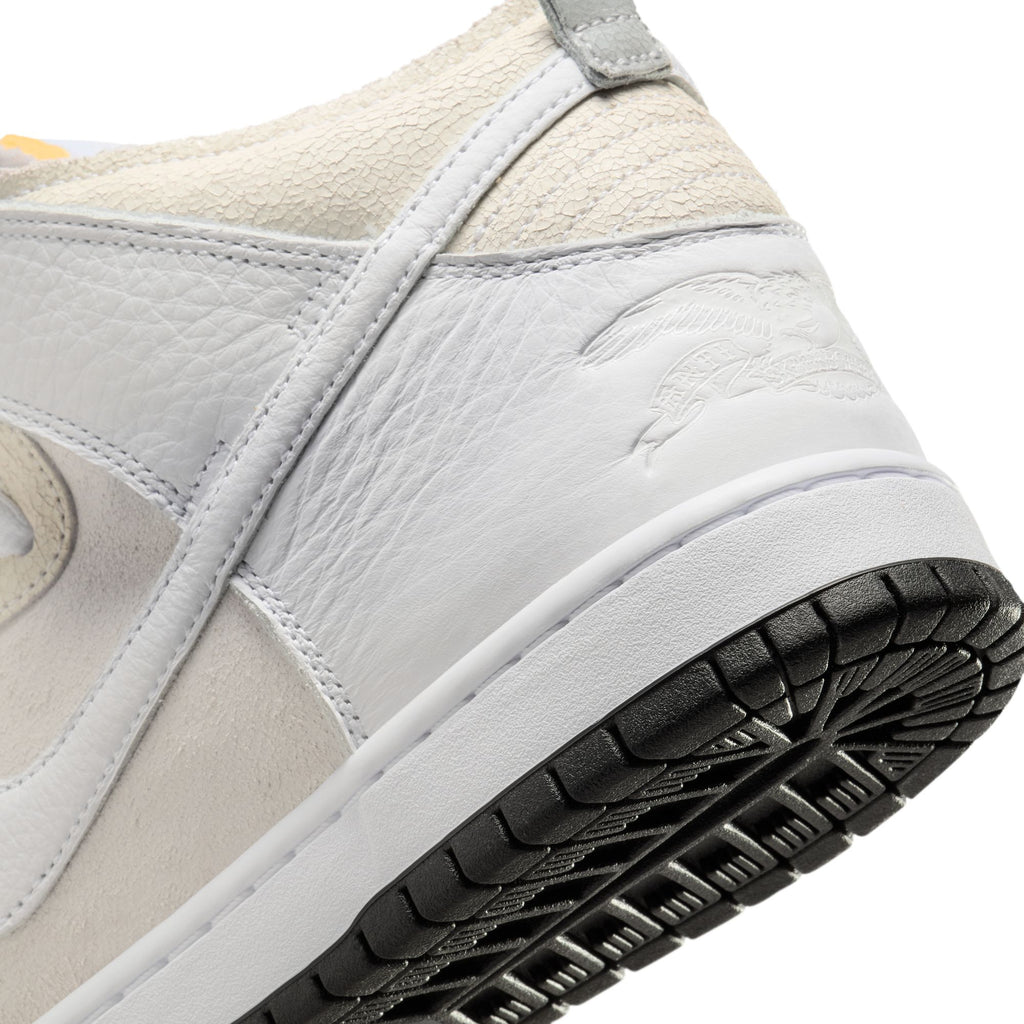 A close-up of the NIKE SB X ANTIHERO DUNK HIGH in white, featuring textured leather accents, a raised logo, and a black rubber sole.