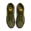 Top view of a pair of NIKE SB X ANTIHERO BLAZER GT MID sneakers in Rough Green and Amarillo, featuring black soles, displayed side by side on a white background. Ideal for skateboarders or streetwear enthusiasts.