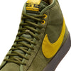 Close-up of a NIKE SB X ANTIHERO BLAZER GT MID sneaker in rough green with amarillo accents, reminiscent of the iconic ANTIHERO DUNK HIGH. The brand name "nike" is prominently displayed on the tongue.