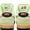 Close-up of the heels of two light green nike SB Dunk Low Pro Verdugo Mountain sneakers with pink "NIKE" lettering, map and bicycle graphics on the back tabs, inspired by mountain biking in the Verdugo Mountains.