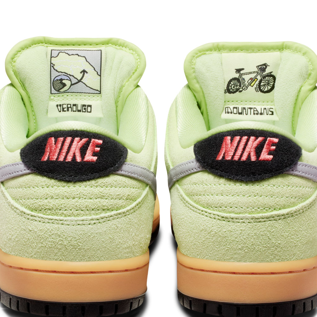 Close-up of the heels of two light green nike SB Dunk Low Pro Verdugo Mountain sneakers with pink "NIKE" lettering, map and bicycle graphics on the back tabs, inspired by mountain biking in the Verdugo Mountains.