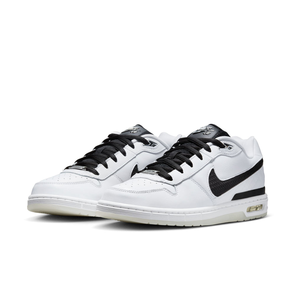 A pair of NIKE SB P-ROD 1 ZOOM AIR LOW 20 YEARS sneakers in white/black-white-clear by Nike, featuring black swooshes, black laces, and visible Zoom Air cushioning, displayed on a white background.