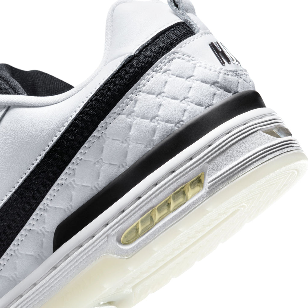 Close-up of the heel of the NIKE SB P-ROD 1 ZOOM AIR LOW 20 YEARS in white/black-white-clear, featuring a black stripe, textured pattern, Zoom Air cushioning, and a translucent outsole—ideal for skateboarding enthusiasts or CSEF supporters.