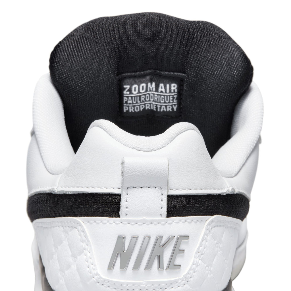 Close-up of the heel and tongue of the Nike SB P-ROD 1 Zoom Air Low 20 Years sneaker in white/black, displaying "ZOOM AIR PAUL RODRIGUEZ PROPRIETARY" on the tongue label, honoring skateboarding scholarships and education.