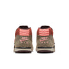 Rear view of the NIKE SB X ARTS-REC AIR TRAINER 1 in Limestone/Pink Quartz-Earth-Dusty Peach-Black-Desert Sand, showcasing pink accents and a bold brown animal print on the heel.
