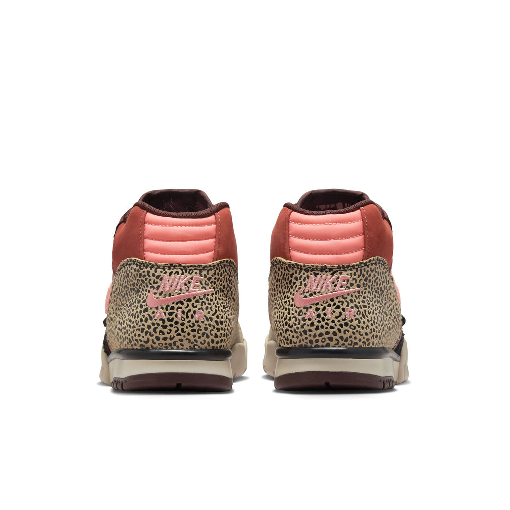 Rear view of the NIKE SB X ARTS-REC AIR TRAINER 1 in Limestone/Pink Quartz-Earth-Dusty Peach-Black-Desert Sand, showcasing pink accents and a bold brown animal print on the heel.