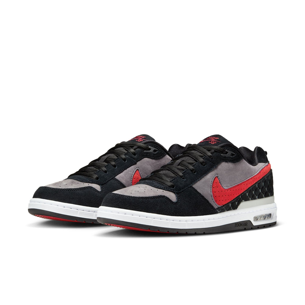 The nike SB P-ROD 1 Zoom Air Low Black/Varsity Red-Flint Grey-Black features black, grey, and red color blocking, a red Nike Swoosh, visible Air cushioning in the heel, and is inspired by Paul Rodriguez's signature shoe.