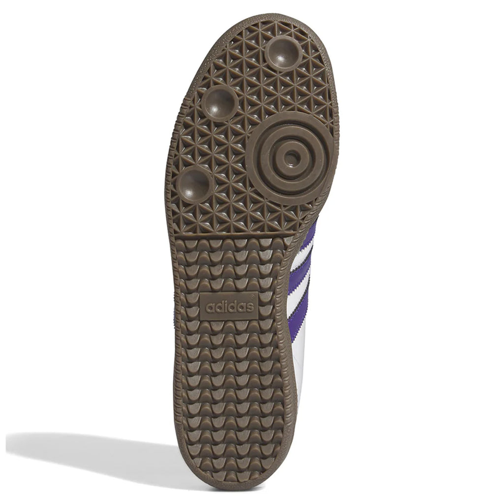 The outsole of the Adidas Samba ADV Cloud White / Collegiate Purple Shoes showcases a brown rubber surface adorned with tread patterns, circular grips, and the Adidas logo at the center. The upper features white and purple stripes, enhanced by Adituff toe reinforcement for increased durability.