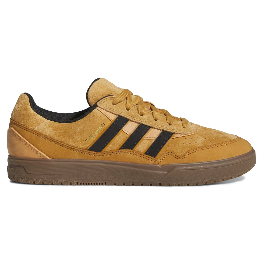 The ADIDAS TYSHAWN 2 in mesa, core black, and gum offers impact cushioning and a stylish design, featuring tan athletic shoes with black stripes and a gum sole, ideal for skateboarders.