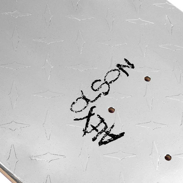 Close-up of the violet VIOLET X ALEX OLSON SILVER METAL skateboard deck, featuring a diamond plate pattern and "ALEX OLSON" in distressed black text near the mounting holes.
