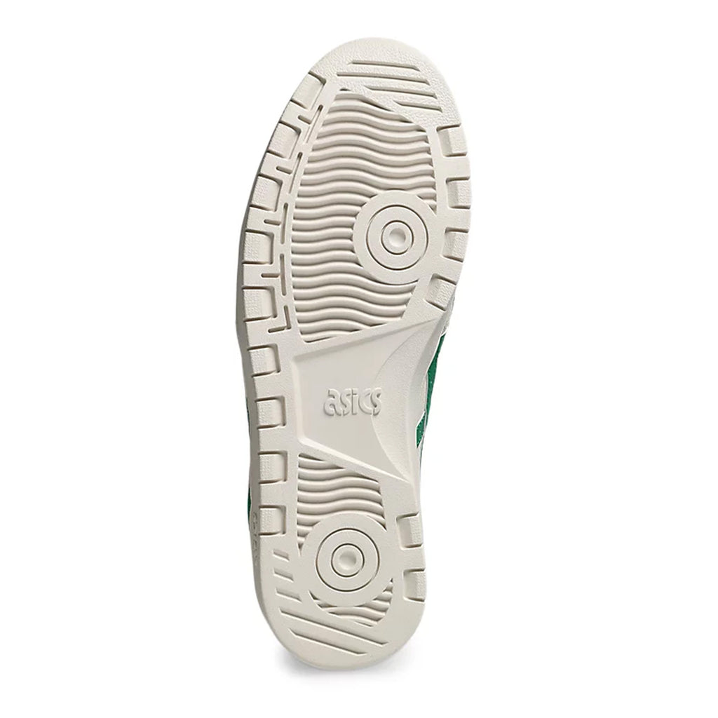 Bottom view of a ASICS skateboarding shoe showing a beige rubber sole with textured patterns and a green logo detail.