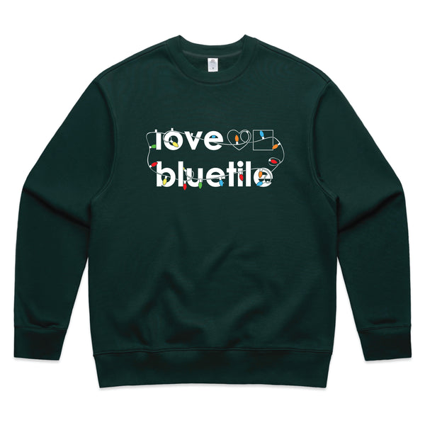 A Bluetile Skateboards "Ugly Sweater" Crewneck Pine Green sweatshirt with the word love on Bluetile on it.