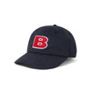 A Butter Goods BUTTER GOODS B LOGO 6 PANEL HAT NAVY with a CANVAS PATCHWORK 6 PANEL HAT design, in WASHED NAVY color, featuring the letter b on it.