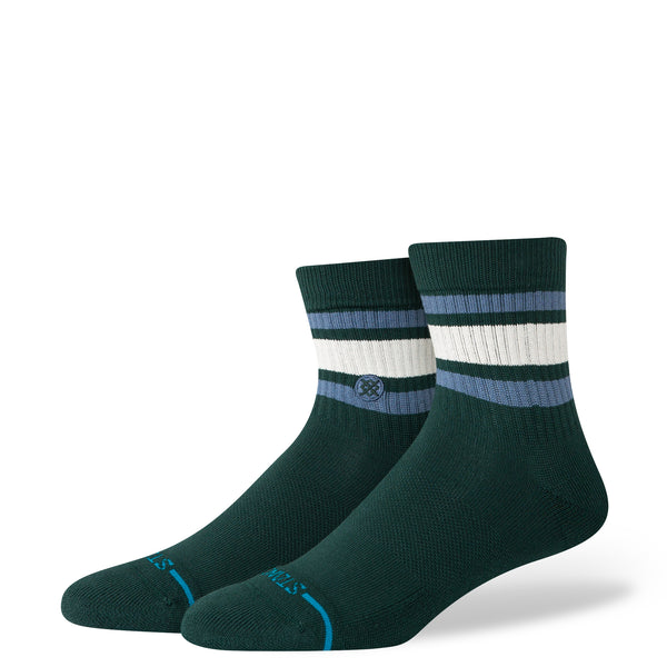 The STANCE SOCKS BOYD QUARTER PINE LARGE are dark green combed cotton socks with white and light blue stripes near the top and a small circular logo on the side.