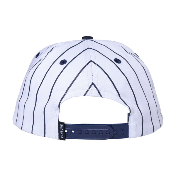 Back view of the Carpet Co. VENTURE X BRONZE 56K PINSTRIPE HAT, a white trucker hat with black pinstripes, featuring an adjustable blue strap and a subtle black screen-printed logo.