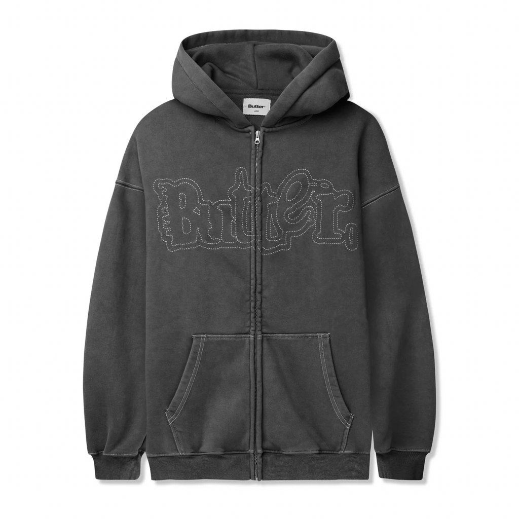 A washed black zip-up hoodie featuring a front pocket and "Butter." embroidered in white stitching across the chest, showcasing the stylish flair of Butter Goods, known as the BUTTER BREAKDOWN ZIP-THRU HOODIE.