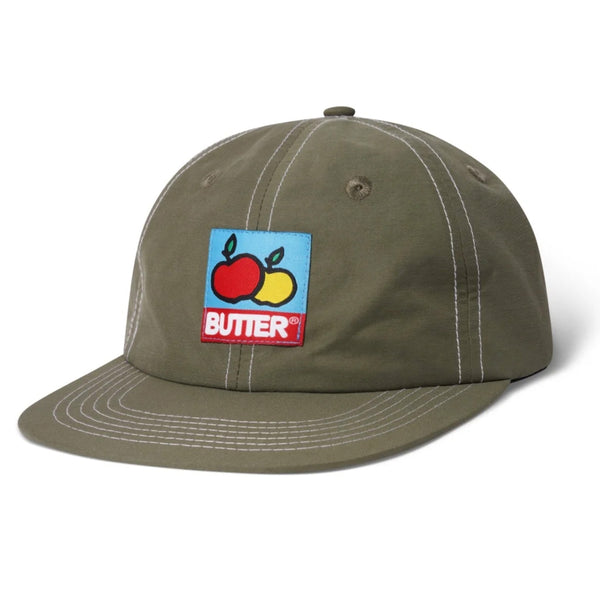 A BUTTER GOODS GROVE 6 PANEL HAT ARMY with a front label featuring the butter logo.