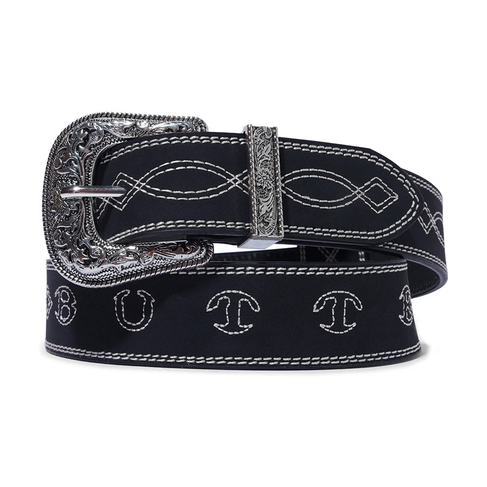 The Loosey BUTTER BRONCO BELT BLACK is a black PU leather belt with contrast stitching, ornate Western metal buckle, and white embroidered patterns and lettering along its length.