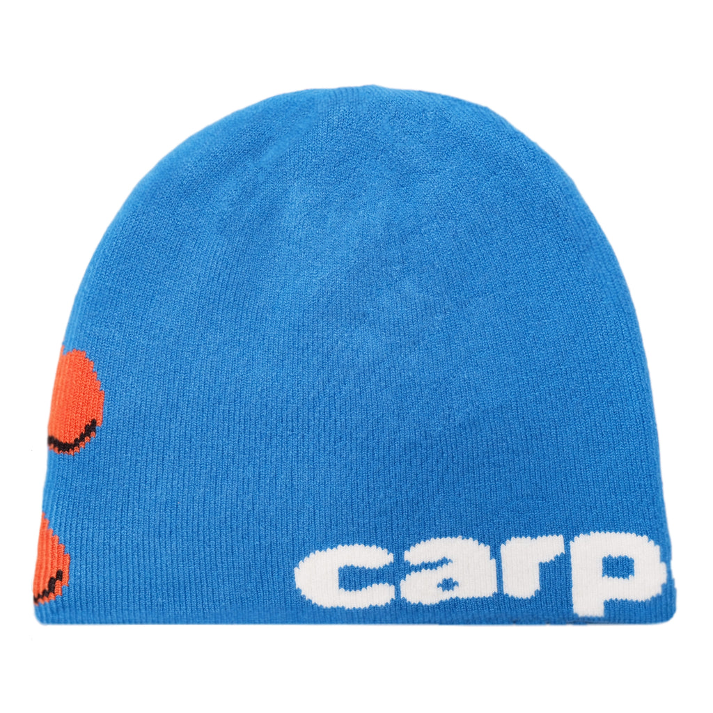 Carpet Co.'s BACTERIA REVERSIBLE BEANIE BLUE features the word "carp" in white text, partially visible orange fish graphics on the left side, and the stylish BRAT LOGO.