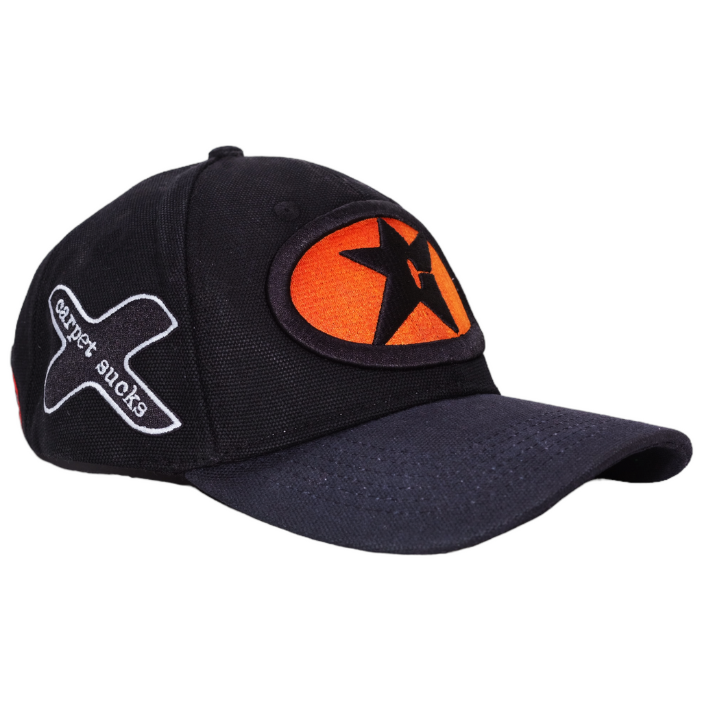 A Carpet Co. black baseball hat with an orange star on it.
