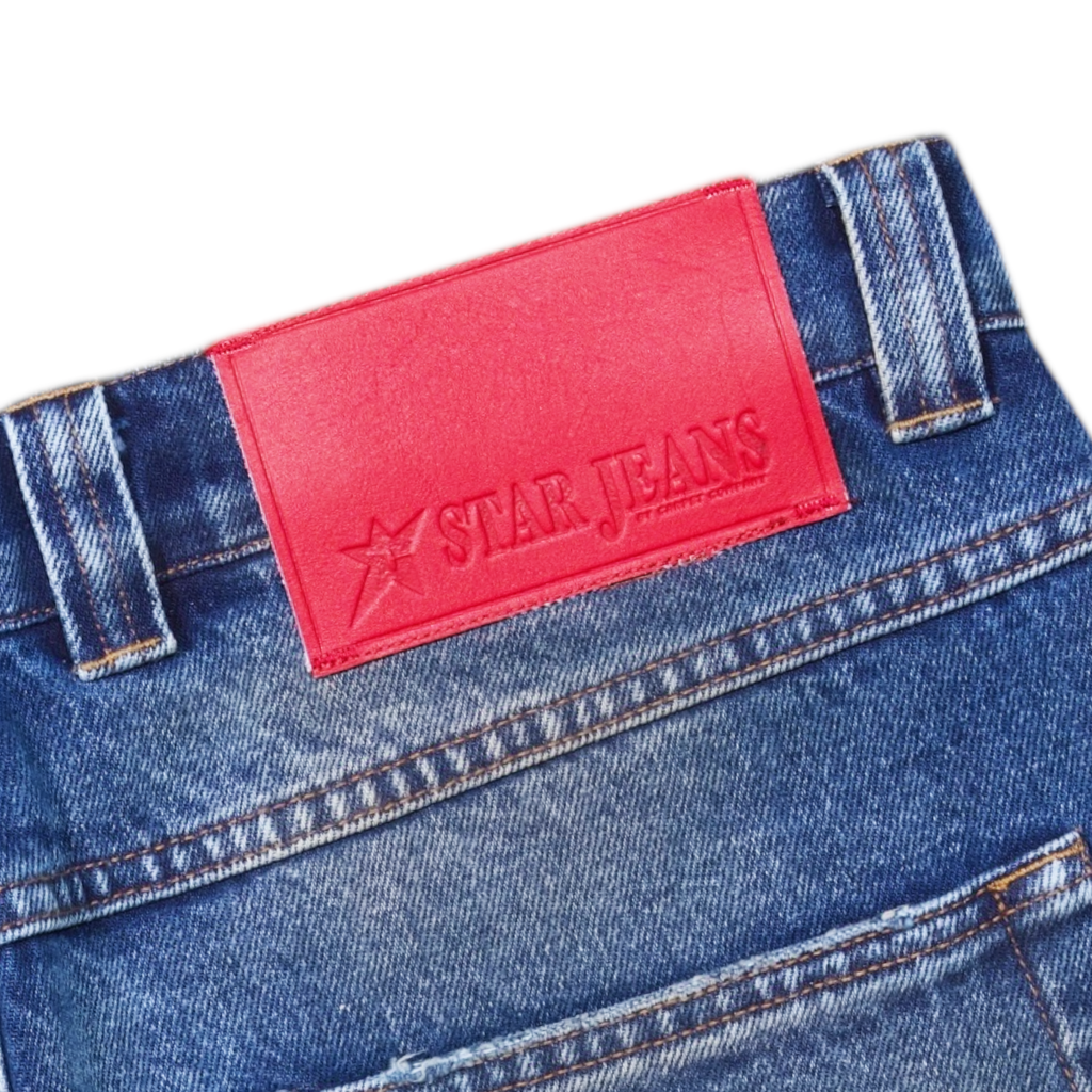 Close-up of CARPET CO. C-STAR JEANS WASHED BLUE from POLAR, crafted from premium cotton with a distinct red "Star Jeans" label.