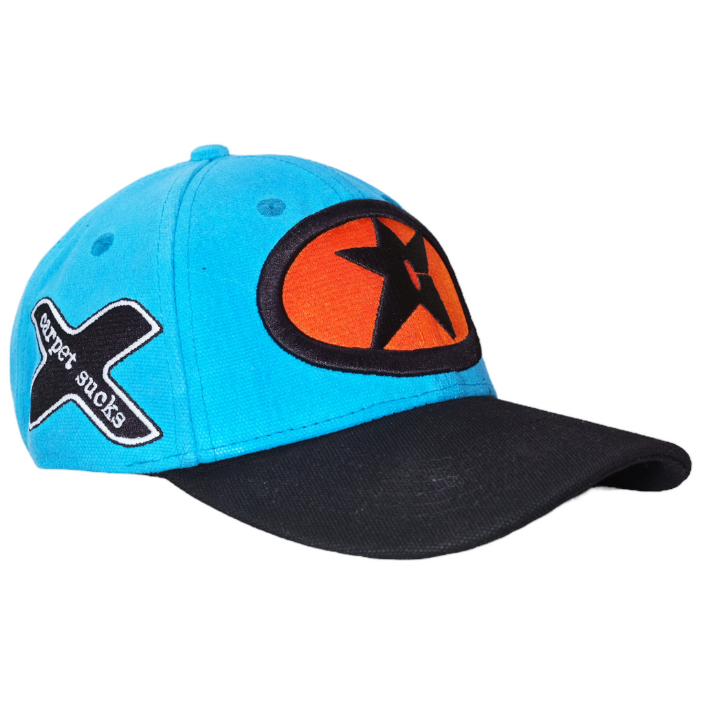 A CARPET RACING HAT CYAN with an orange star on it, by Carpet Co.