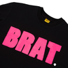 Carpet Co. black t-shirt with the word "brat" printed in bold rose pink letters on the front, featuring a round neckline and a visible tag on the collar.