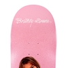 The WELCOME X BRITNEY BABY ONE MORE TIME skateboard deck, produced by WELCOME, features a pink background with "Britney Spears" written in white script at the top and boasts an elongated egg shape for enhanced control.