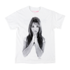 WELCOME X BRITNEY BELIEVE TEE WHITE with a grayscale image of a young woman with long hair, hands pressed together in front of her face, and eyes looking forward. This screen-printed tee from WELCOME features a unique front and back design.