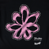 A black background featuring a pink, stylized flower design surrounded by lines of white text that outline the flower. The text includes phrases like "baby," "give me a sign," and musical notes, capturing the rustic charm of a cowgirl's garment-dyed tee. Introducing the WELCOME X BRITNEY FLOWER TEE BLACK by WELCOME.