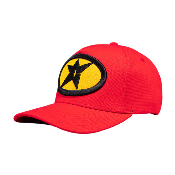 The CARPET GAS STATION HAT RED from Carpet Co. is a red baseball cap adorned with a yellow and black star emblem on the front and complemented by intricate black embroidery.