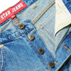Close-up of classic C Star denim jeans with a red "STAR JEANS" label, brown star-shaped buttons, and orange stitching—ideal to pair with your CARPET CO. C STAR FADED DENIM SHORTS by Carpet Co.