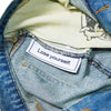 Close-up of the inside of CARPET CO. C STAR FADED DENIM SHORTS by Carpet Co., showing a "Lose yourself." label sewn onto the inner lining.