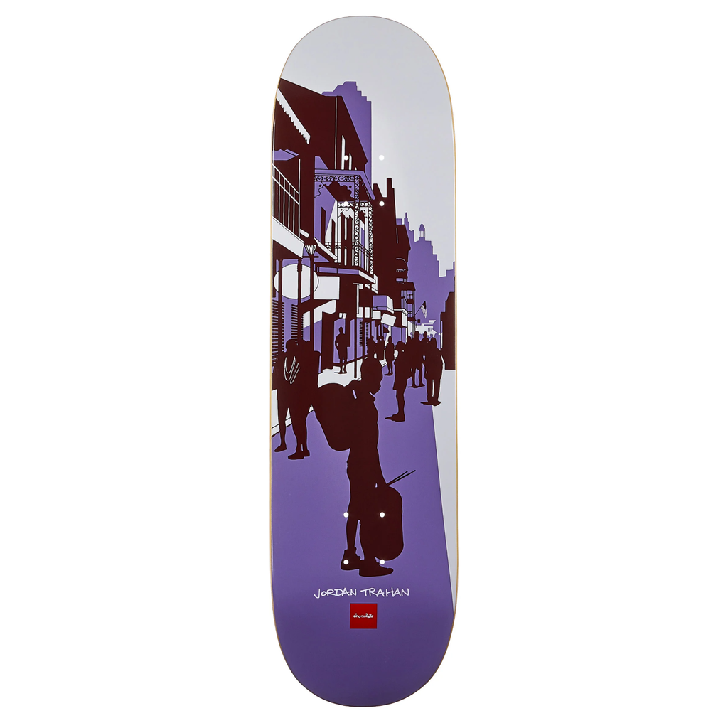 A skateboard deck with a purple toned graphic of people standing on a street.