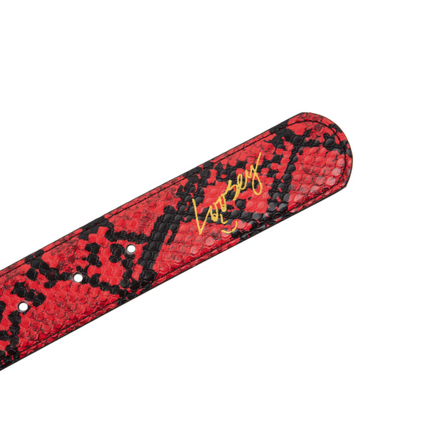 A Loosey Slither Red Belt with an embossed black logo on it.