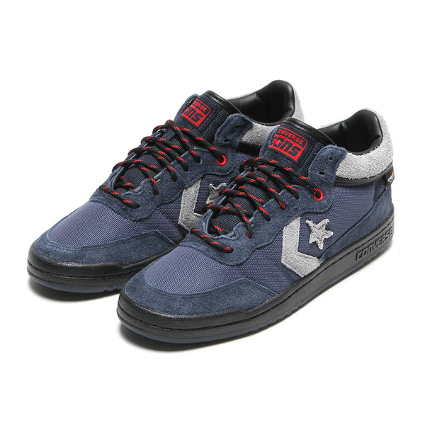 Introducing the CONVERSE CONS FASTBREAK PRO MID CORDURA™ in Obsidian and Dark Waters, these stylish sneakers are adorned with the classic star logo, red accents, and black soles. They feature CX cushioning for exceptional comfort and are crafted from durable Cordura™ fabric to handle everyday adventures.