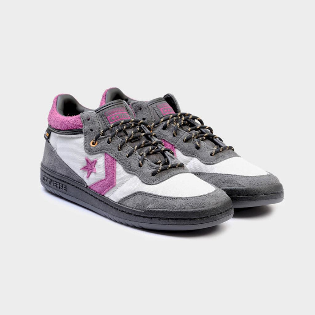 These sneakers, the CONVERSE CONS FASTBREAK PRO MID CORDURA™ in Dark Matter/Barely Grey, showcase the iconic Converse logo on the side. Made from resilient Cordura™ canvas and adorned with purple accents and black laces, they offer CX cushioning for ultimate comfort, encapsulating classic style.