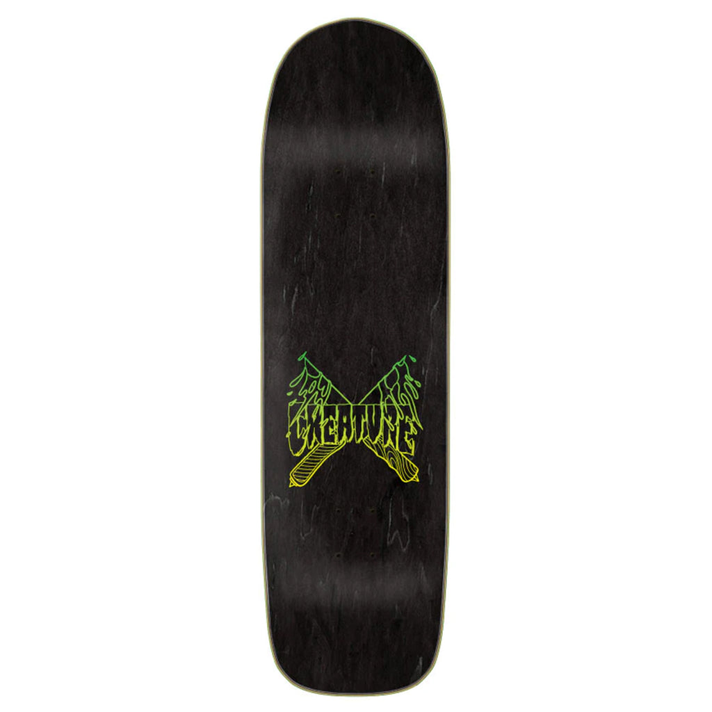 A black CREATURE skateboard with a green logo on it (specifically the Martinez Stab-BQ model).