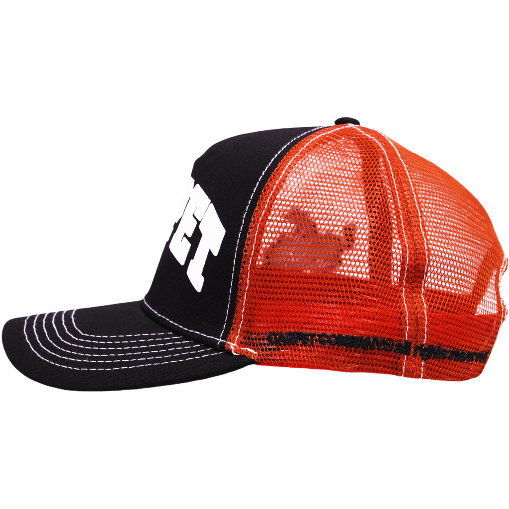 Introducing the Carpet Co. CARPET COWBOY TRUCKER BLACK: a stylish black and orange hat featuring white stitching and a printed logo on the front. The side showcases a distinctive mesh pattern that's perfect for any carpet cowboy.