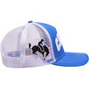 The CARPET COWBOY TRUCKER BLUE by Carpet Co. is a blue and white trucker hat featuring a black embroidered bull and rider design on the side, perfectly capturing rugged charm ideal for a gas station aesthetic.