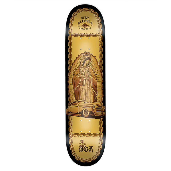 The DGK ORTIZ LO-SIDE skateboard by DGK features a Virgin Mary illustration, classic car, gold chains, and the words "STAY BLESSED" and "DGK" on a sleek black and gold Yin Yang Deck.